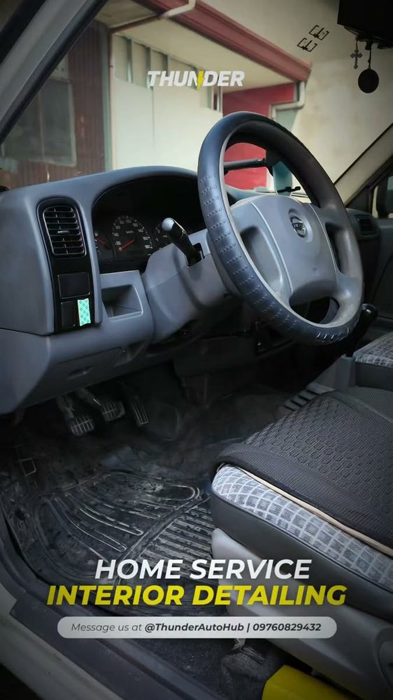 Technician detailing a car interior at the customer's home